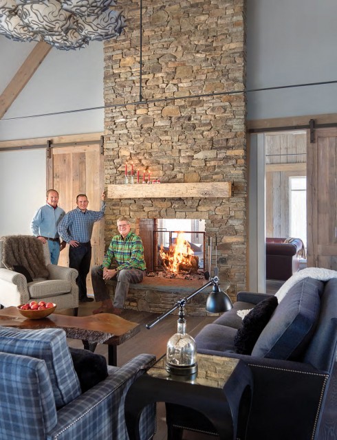 John Steel (left) president and owner of Steel Construction (builder of the Beechers' house in Stowe) joins the company's site supervisors John Hudgens (center) and Paul Kartluke at the house's floor-to-ceiling fireplace.
