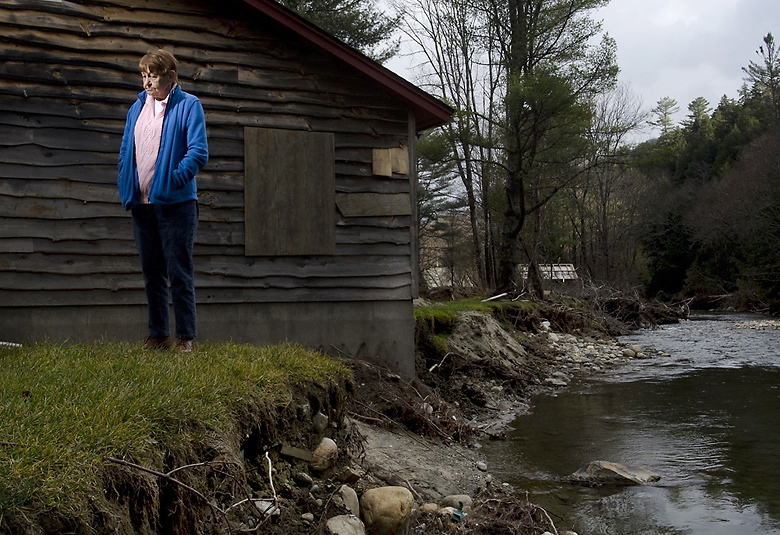 Dotty Casciotta, 80, of Stockbridge, stands outside of her destroyed A-frame home in Chalet Village on Wednesday Nov. 10, 2011. The Tweed River broke its banks during Tropical Storm Irene and flooded the riverside neighborhood. / EMILY McMANAMY, Free Press 